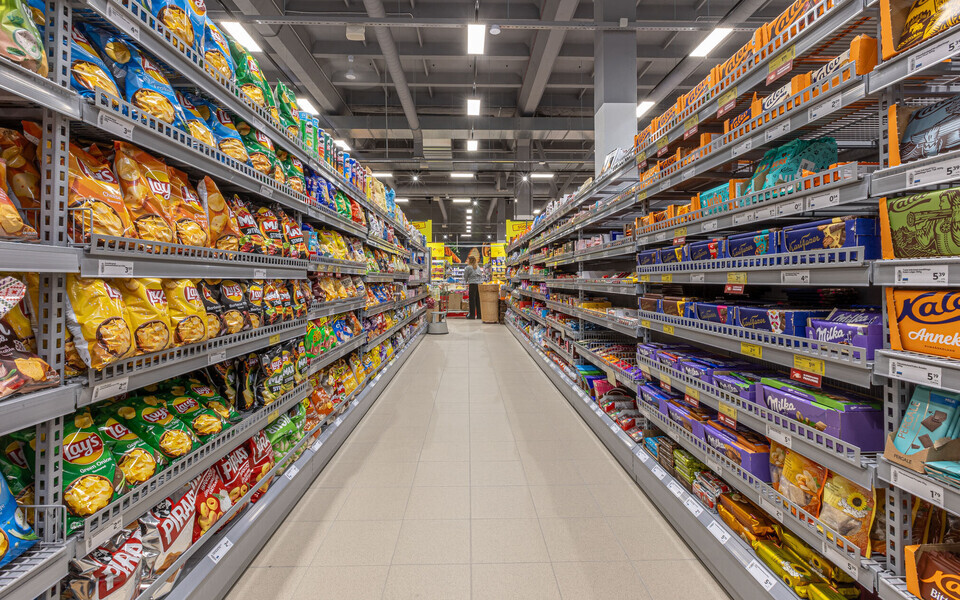 Snacks and candies aisle in a supermarket.