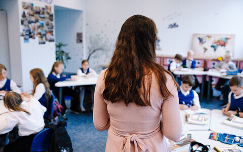 Teacher in front of a classroom full of kids. Photo is illustrative.