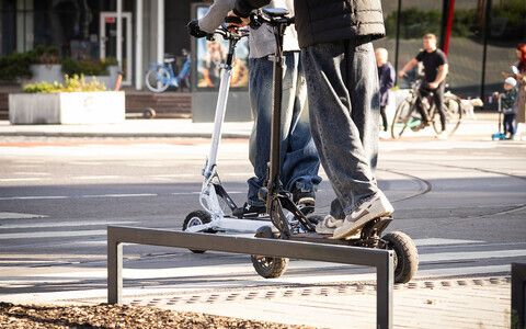 E-scooter riders crossing at a crosswalk in Tallinn.