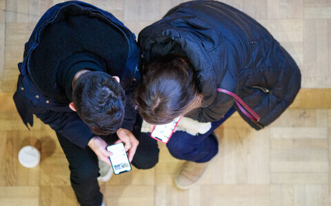 Teens looking at smartphones. Photo is illustrative,